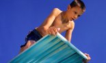 Boy (8-9 years old) afraid of jumping off diving board