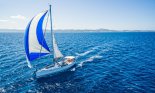 blue sailboat on ocean