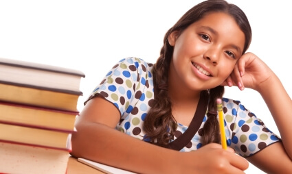 Smiling student with a stack of books