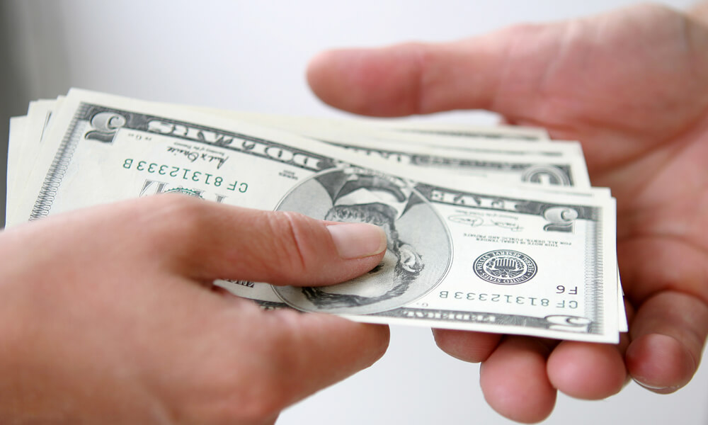 Two people exchanging money, close up of hands