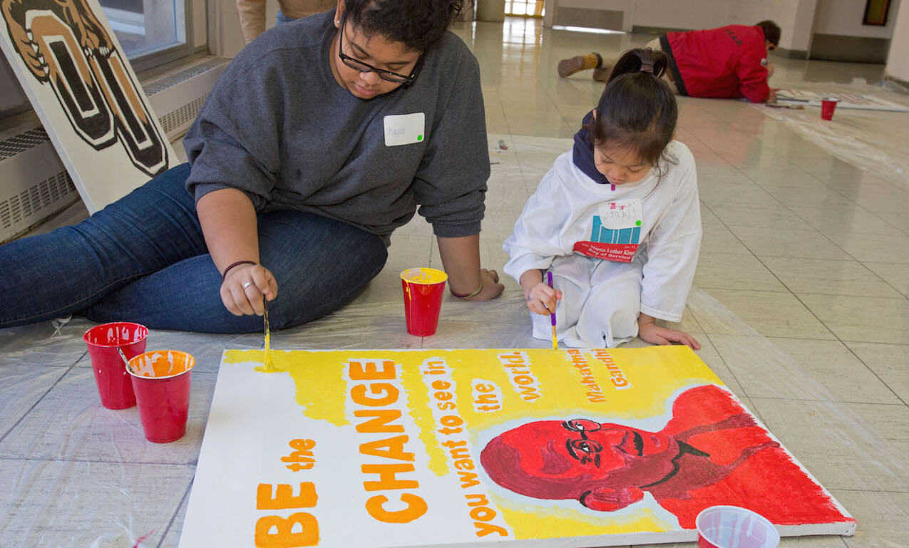 Volunteers painting posters to hang at Detroit Collegiate Prep High School on Martin Luther King Jr. Day, 21st January, 2013