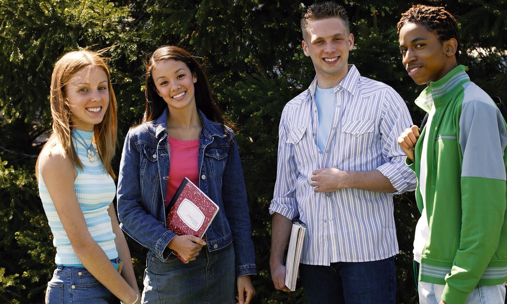 Group of four teenagers (16-17 years old) outdoors