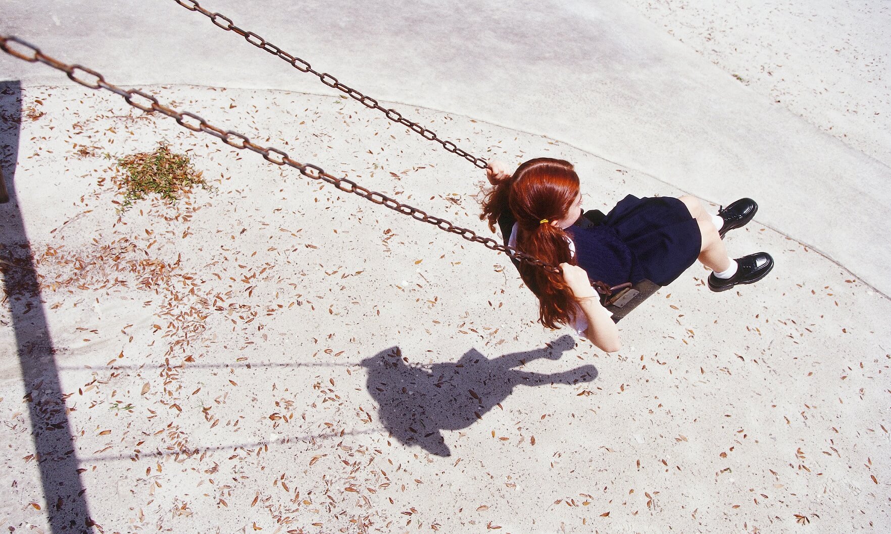 A child plays on a swing alone