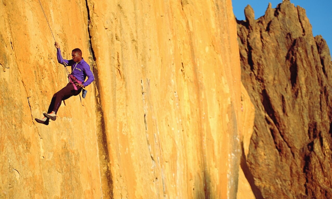 Rock Climber Conquering Steep Rock Face