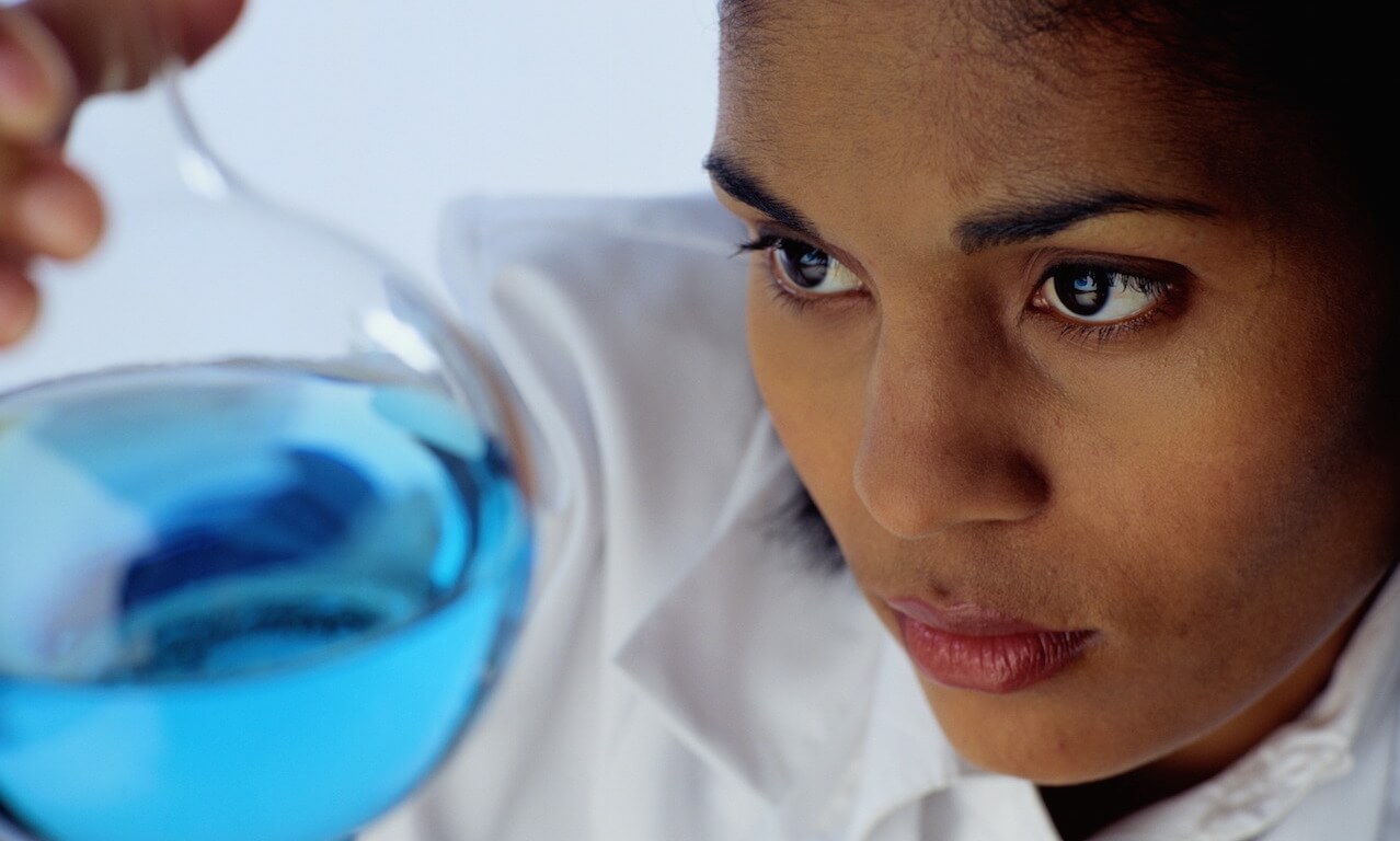 Chemist Examining a Flask of Liquid