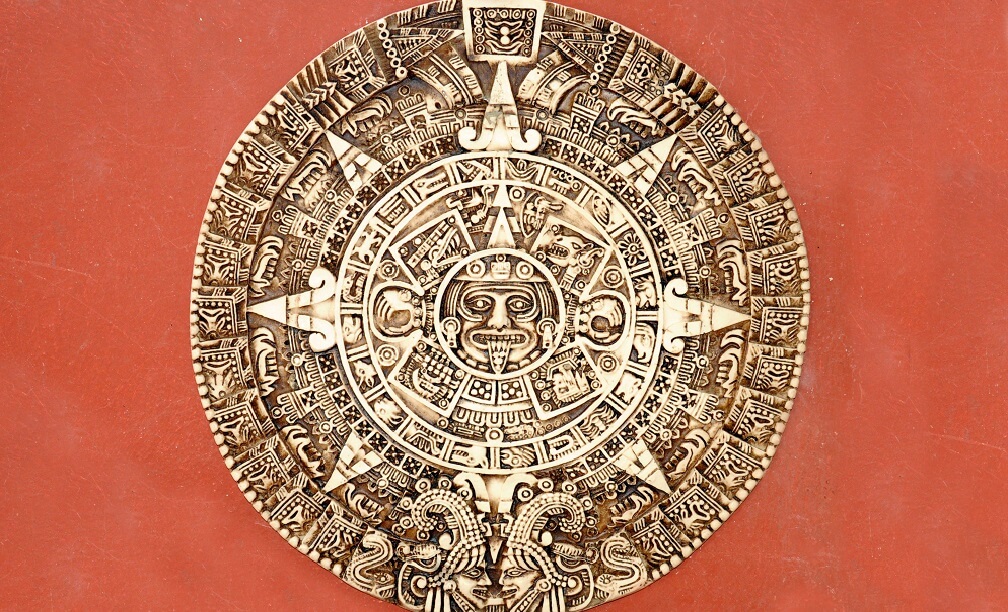 Aztec calendar on a red wall