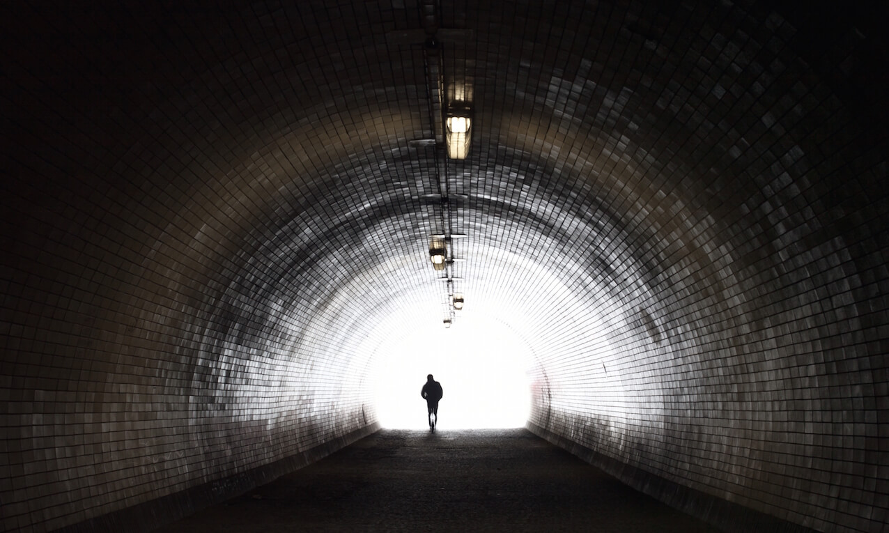 Human Silhouette in Light at The End of The Tunnel