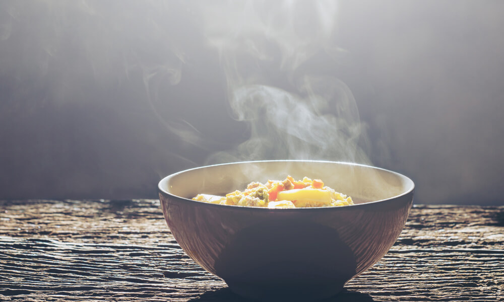 Bowl of hot food with steam rising from it