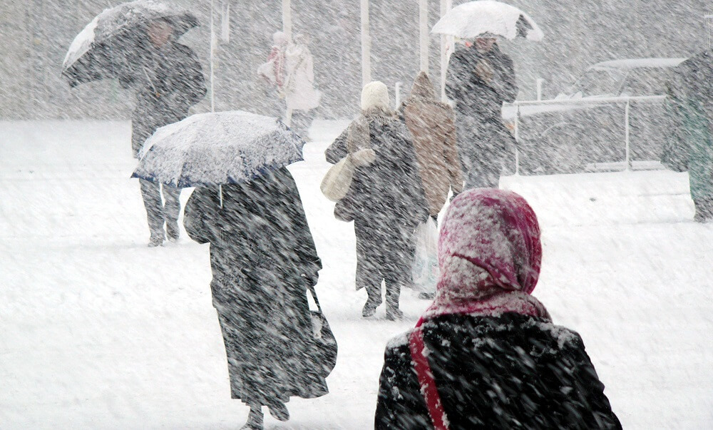 Pedestrians walking in heavy snow