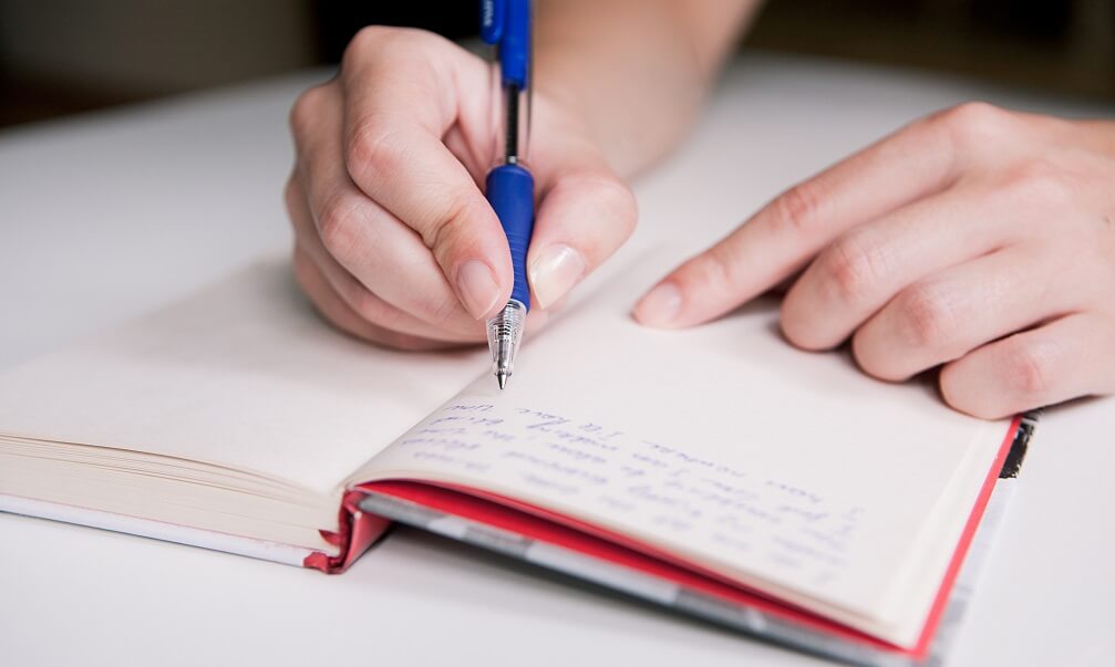 Person writing in a diary