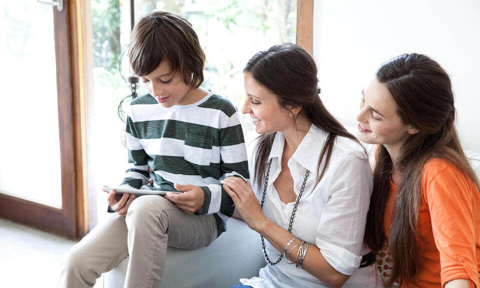 Family using digital tablet togethe