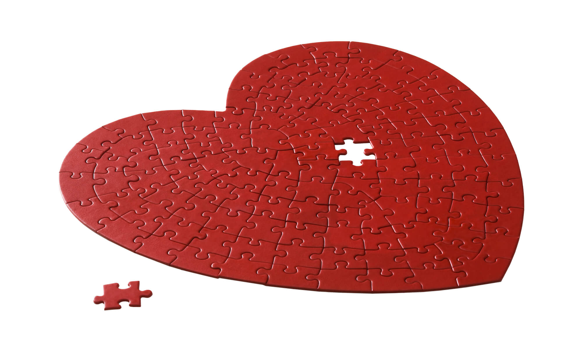red heart shaped jigsaw puzzle on a white background