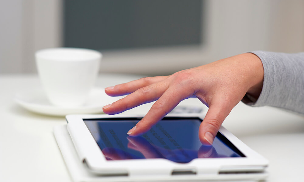 Female hand using digital tablet computer