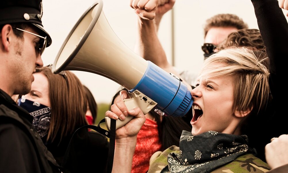 Woman yelling into megaphone at protest