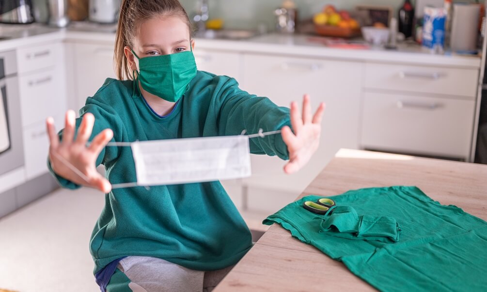 Girl making DIY protective face mask