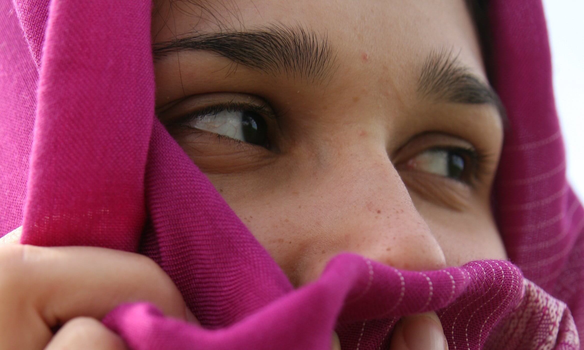 Afghan woman wearing a pink head scarf