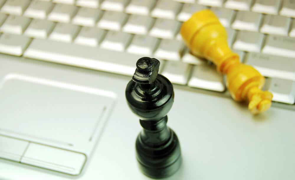 Chess pieces on laptop keyboard