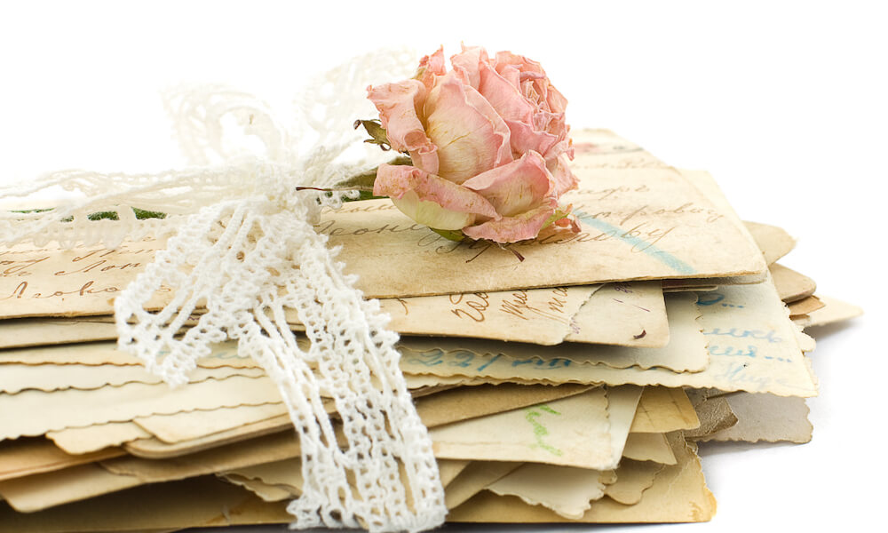 Stack of old love letters (1890-1910), lace and rose flower