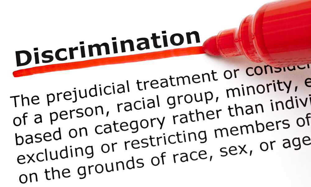 Definition of the word Discrimination underlined with red marker on white paper