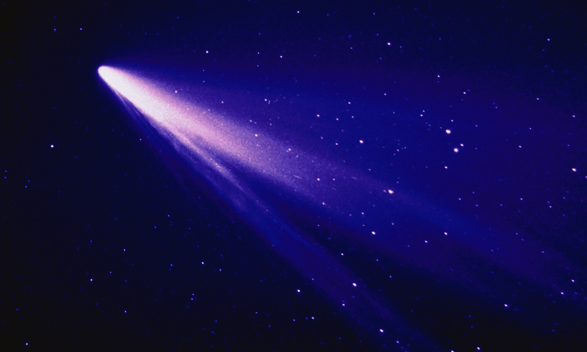 A comet streaking across a starry sky