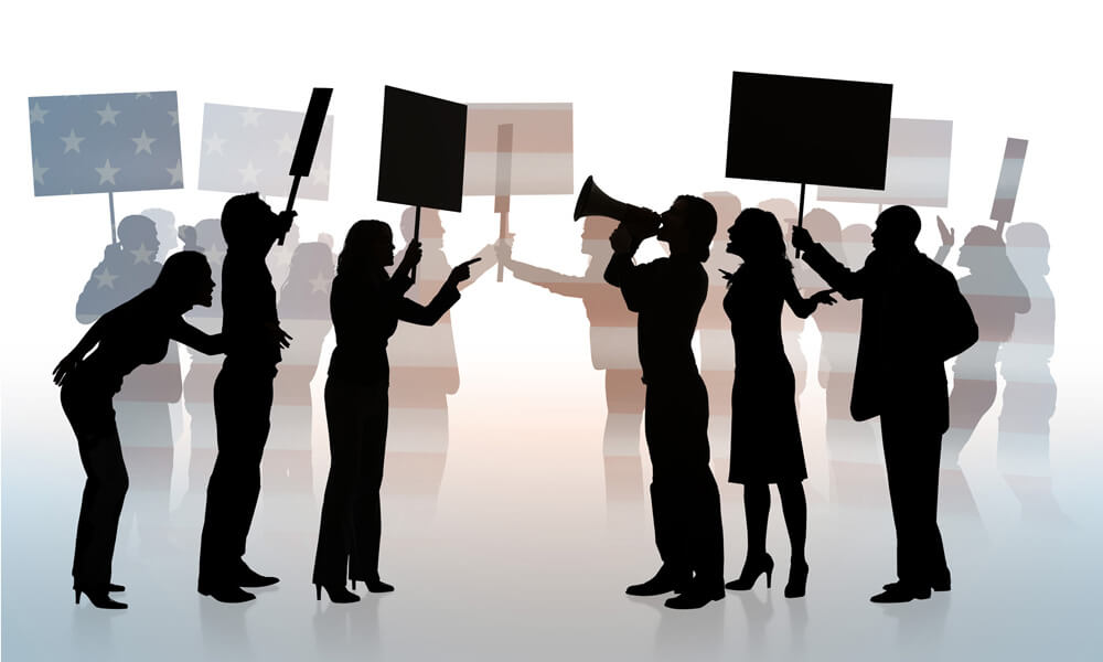 Illustration showing the silhouettes of two opposing groups of people at a political protest