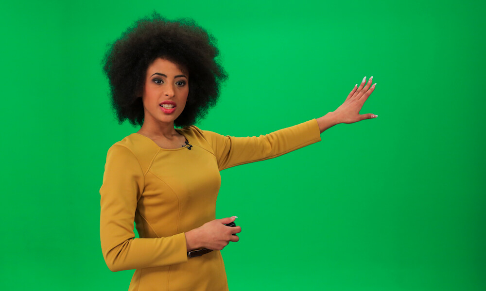 Woman in front of a green screen