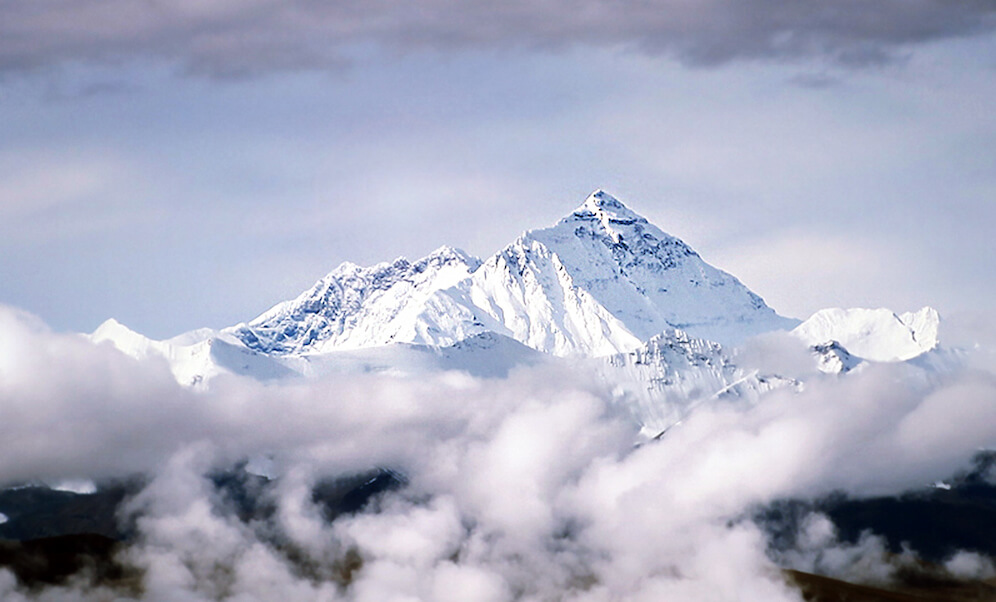 Peak of Mount Everest Above Clouds in Tibet.