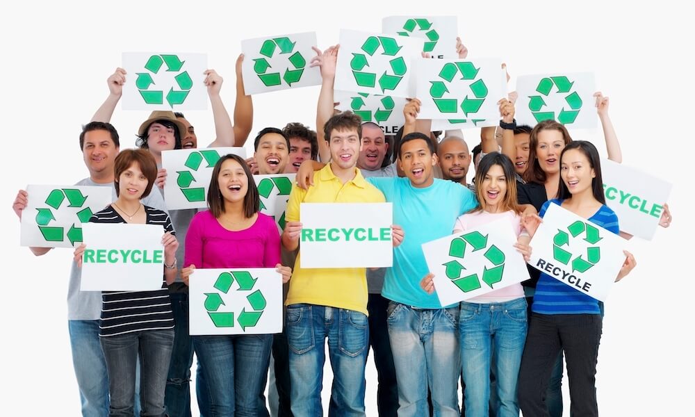 Group of people holding recycle signs