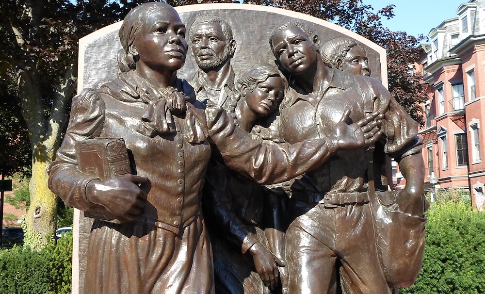 a statue of Harriet Tubman guiding weary slaves to freedom