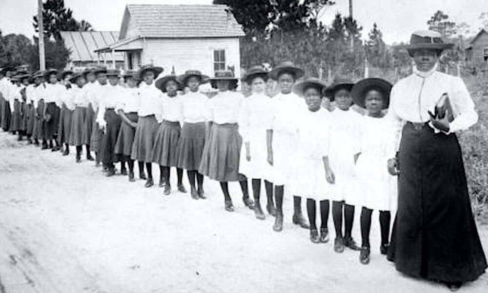 Teacher Mary McLeod Bethune with a line of girls from her school, the Literary and Industrial Training School for Negro Girls, in Daytona, FL in 1905
