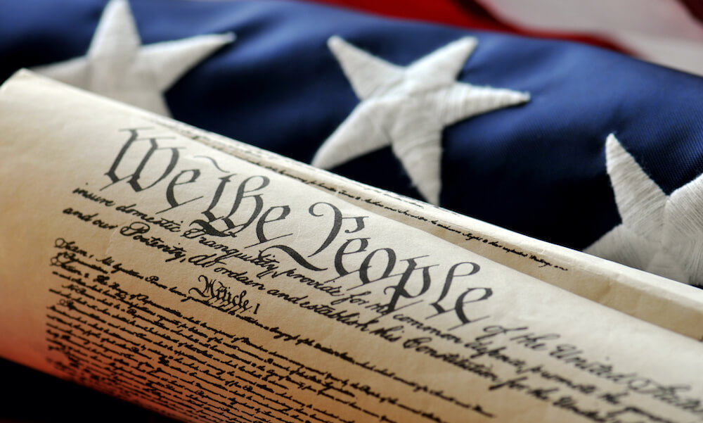 U.S. Constitution document and flag