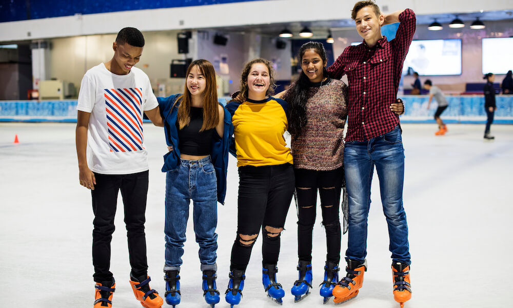 Group of teenage friends on an ice skating rink