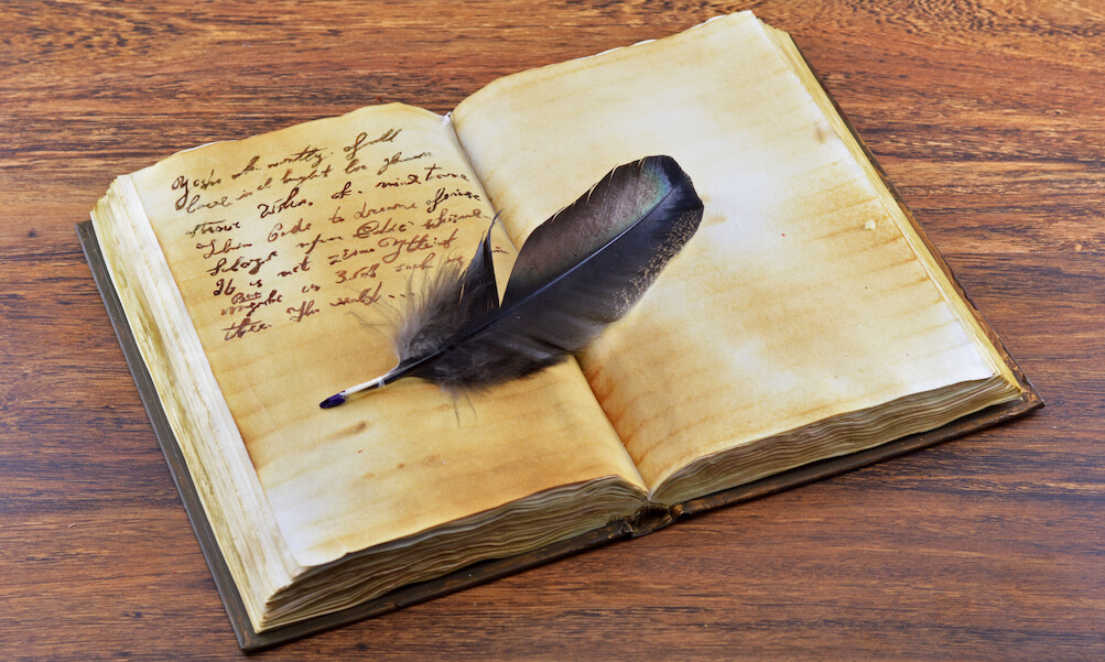 Old book with feather
