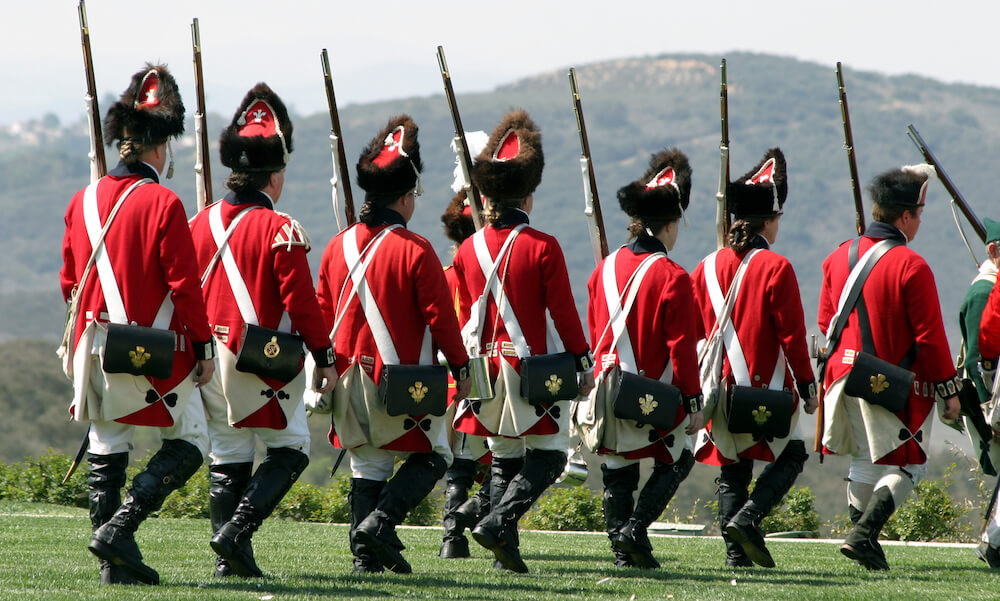Revolutionary war reenactors in red uniforms.
