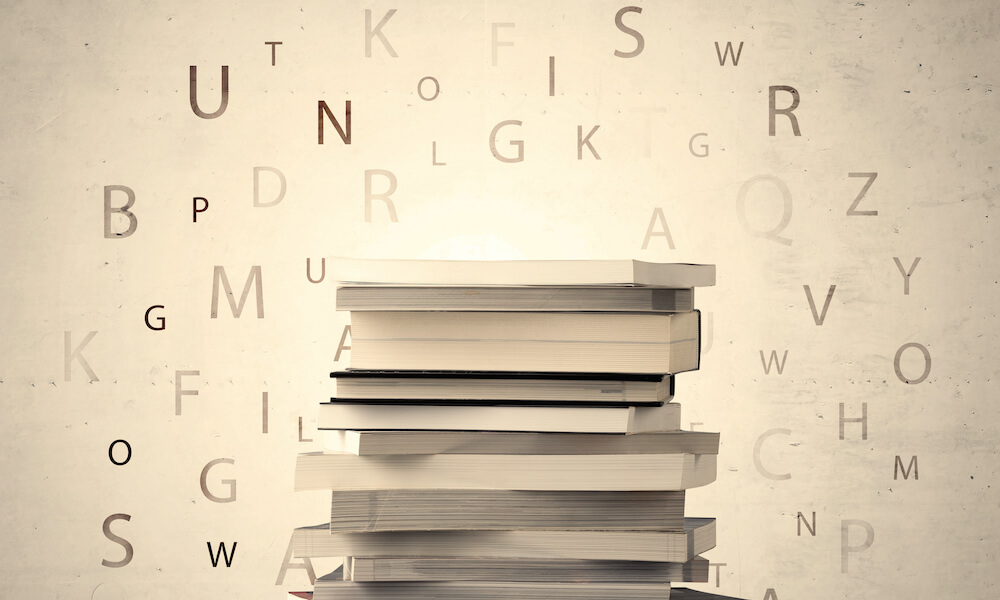 Books with flying letters on vintage old background