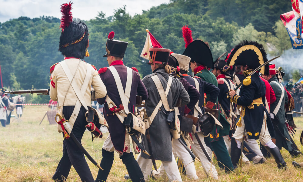 Reenactment of French soldiers marching in a line in 1812