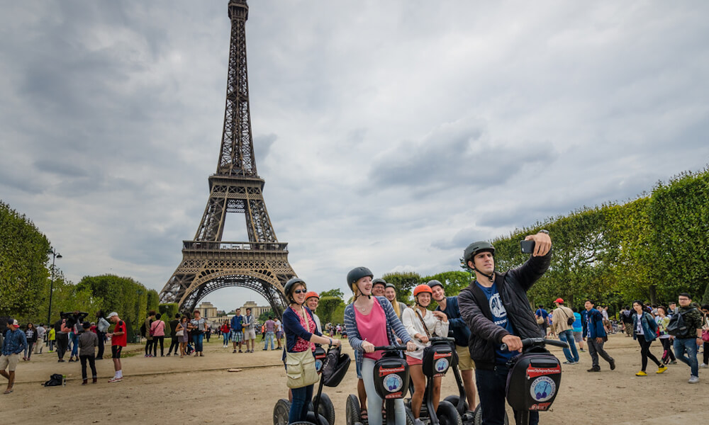 Tourists explore the grounds of the Eiffel Tower