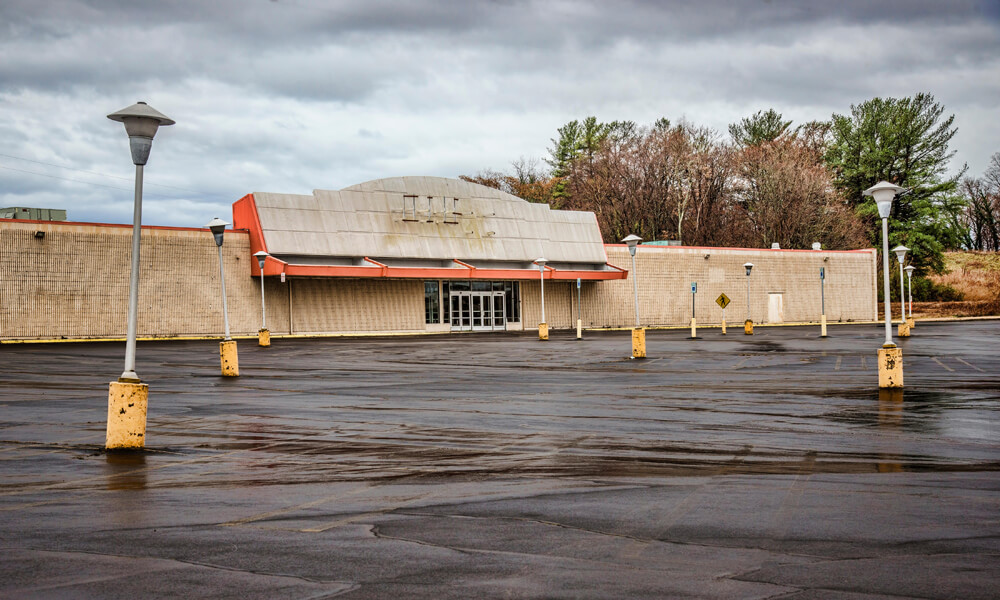 The empty hulk of an unidentified closed discount chain store sits empty.