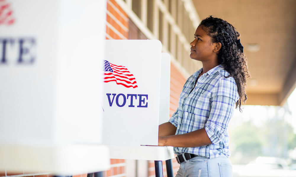 A young black girl voting on election day