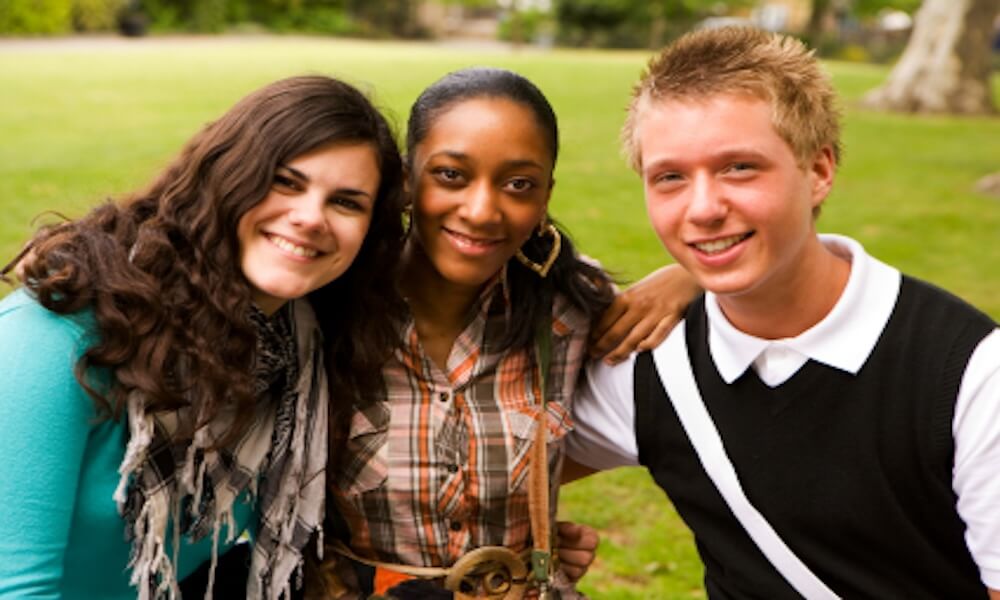 Group of smiling teenage students