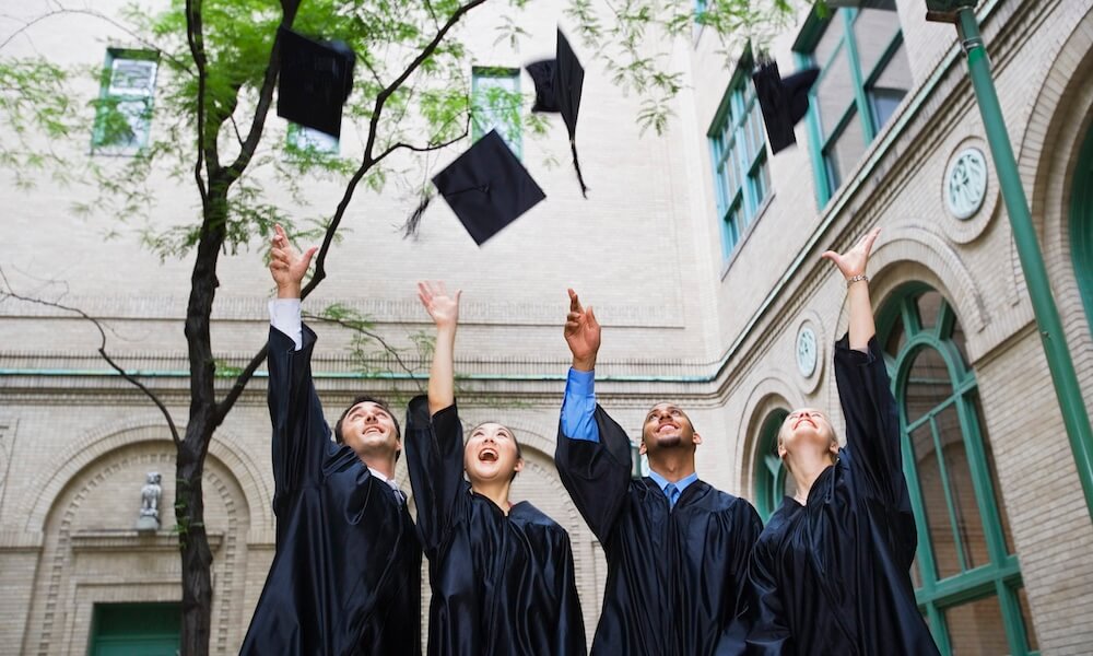 Graduates celebratiing by tossing caps