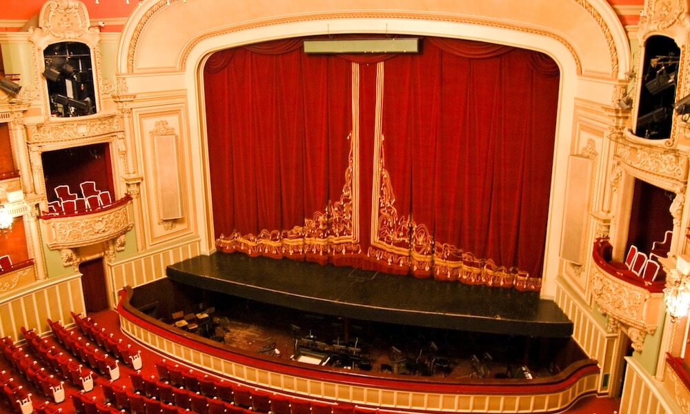 Opera house stage with red curtains
