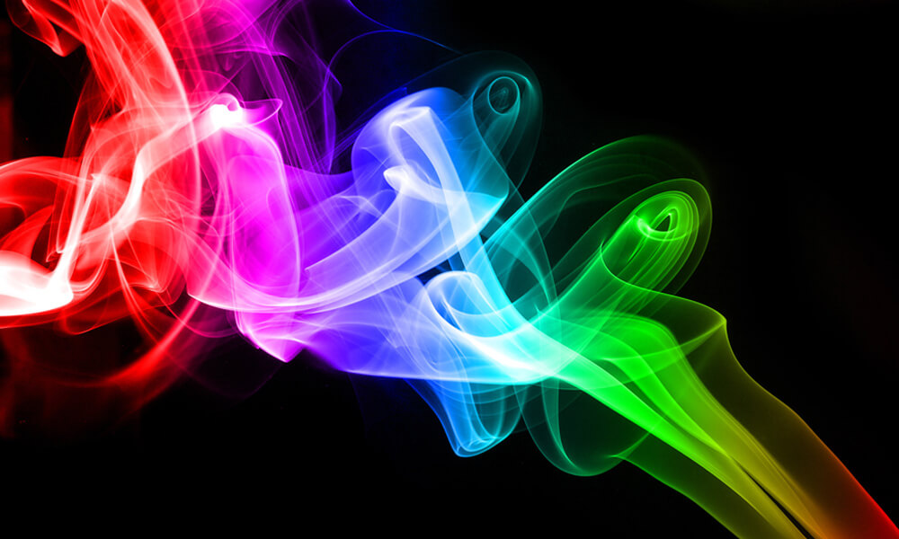 Colorful rainbow smoke on black background