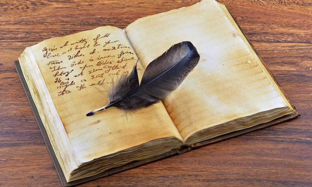 Old book with feather