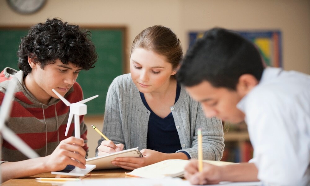 Teenage students studying wind power