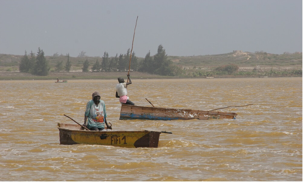 people in boats on Pink Lake in Dakar