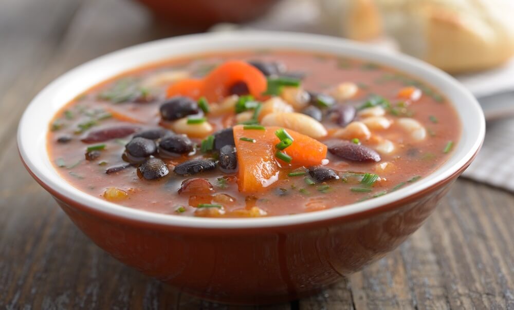 Three bean soup on a rustic table