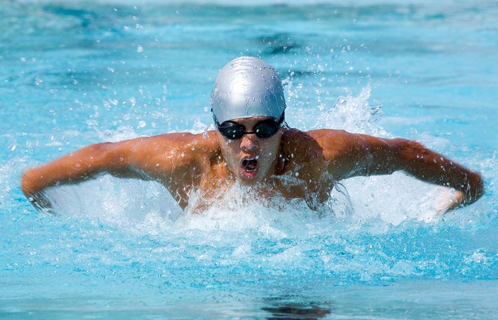 Swimmer (16-17 years old) doing the butterfly stroke