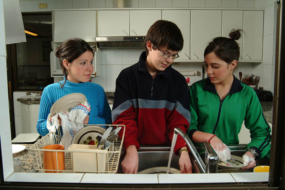 Teens washing dishes