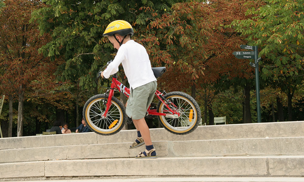 Child on bike in Parc du Luxembourg, in Paris
